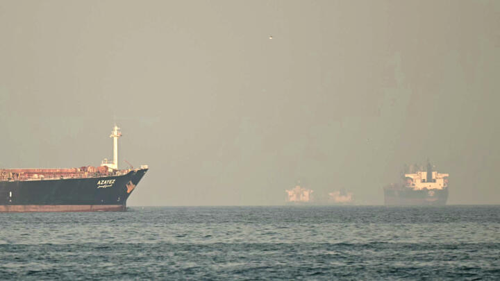 Cargo ships and tankers are seen off coast city of Fujairah, in the Strait of Hormuz in the northern Emirate on February 25, 2026