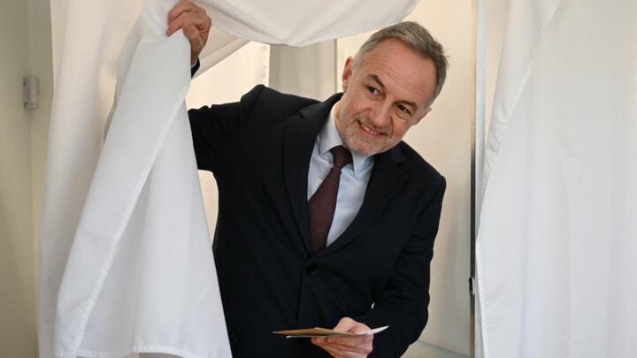Socialist party (PS) mayoral candidate in Paris, Emmanuel Gregoire leaves the voting booth before casting his vote during the first round of France's 2026 municipal elections in Paris.