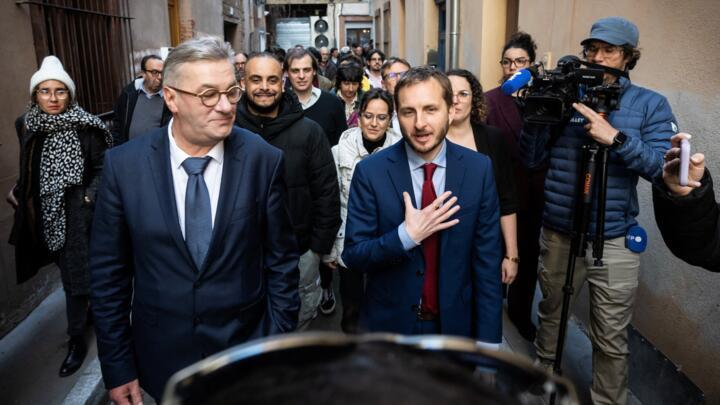 Toulouse mayoral candidates for left-wing "La Gauche Unie" Francois Briancon (L) and left-wing La France Insoumise (LFI) Francois Piquemal (R) walk after a joint press conference following the first r