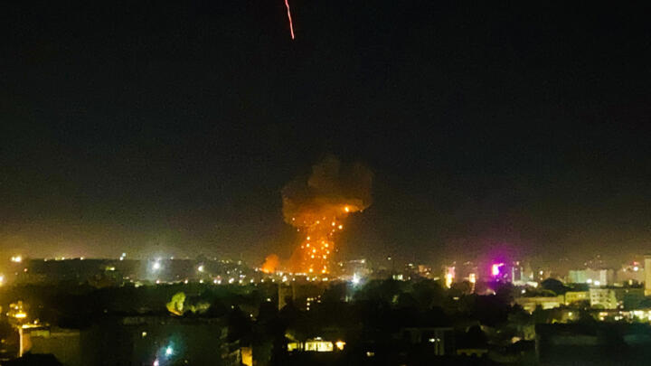 This photograph shows smoke and flames rising from an area hit by airstrikes, in Kabul on March 16, 2026.