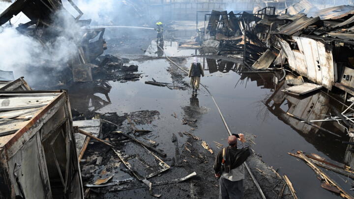Afghan firefighters douse flames at the site after Pakistani air strikes reportedly hit the Secondary Rehabilitation Services Centre in Kabul.