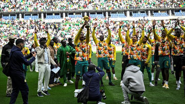 Senegal's players parade with the African Cup of Nations trophy ahead of the international friendly football match between Senegal and Peru at the Stade de France in Saint-Denis north of Paris on Marc