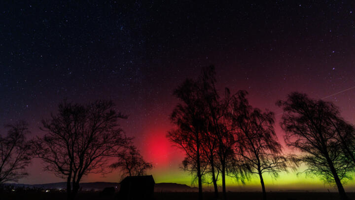 Flickering aurora borealis shines in the night sky over the Loisach Kochelsee Moor near Kochel am See (Bavaria, Germany) on January 19, 2026.
