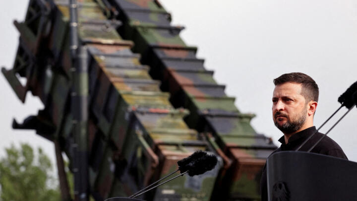Ukrainian President Volodymyr Zelenskiy looks on during a visit to a military training area to find out about the training of Ukrainian soldiers on the “Patriot” anti-aircraft missile system.