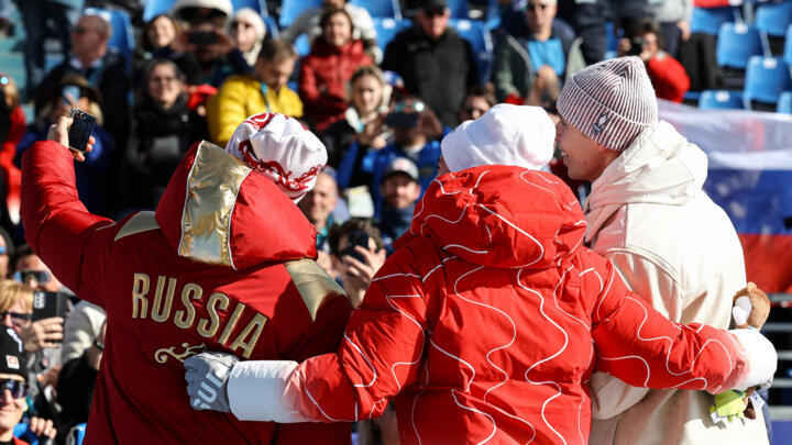 Bronze medalist Aleksei Bugaev of Russia (left) celebrates on the podium after the men's downhill event with gold medalist Robin Cuche of Switzerland and silver medalist Arthur Bauchet of France.