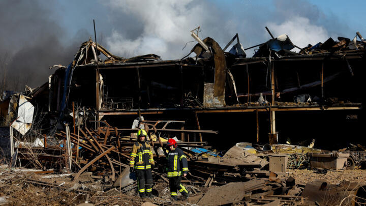 Firefighters inspect an industrial facility damaged during a Russian missile and drone strike in the town of Brovary in the Kyiv region, Ukraine, on March 14, 2026