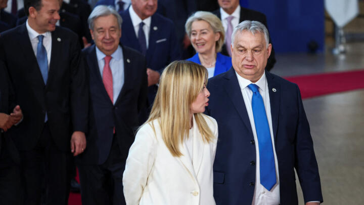 Italian Prime Minister Giorgia Meloni speaks with Hungarian Prime Minister Viktor Orban on the day of a European Union leaders' summit in Brussels, Belgium March 19, 2026.