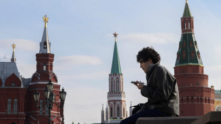 A man checks his mobile phone in central Moscow on March 17, 2026