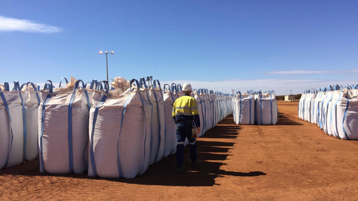 A Lynas Corp worker walks past sacks of rare earth concentrate waiting to be shipped to Malaysia.