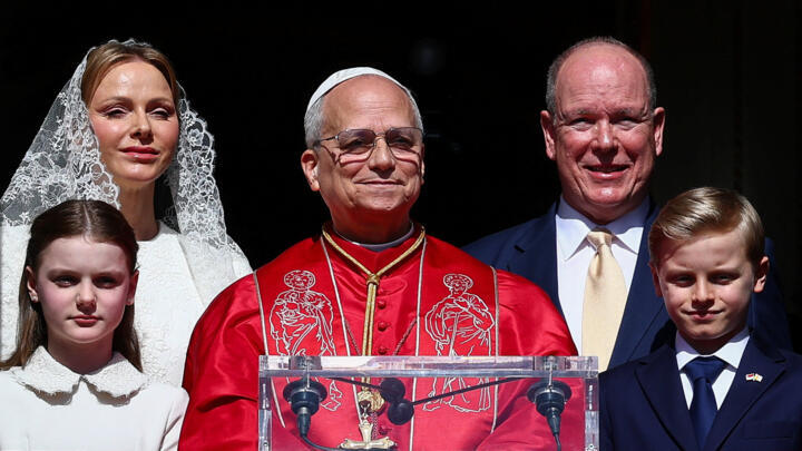 Pope Leo XIV, Prince Albert II of Monaco, Princess Charlene and their children look from a balcony at the Prince's Palace during Pope's one-day trip in Monaco on March 28, 2026.