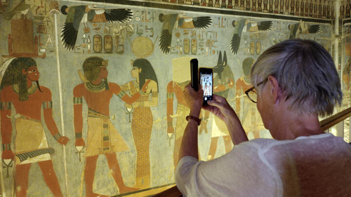 A tourist visits the tomb of King Amenhotep III in the Valley of the Kings near the city of Luxor on October 4, 2025.