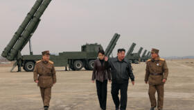 North Korean leader Kim Jong Un and his daughter Kim Ju Ae observing a training exercise.