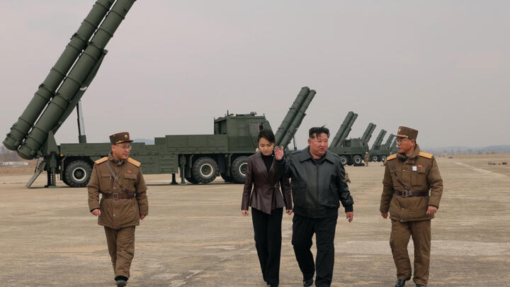 North Korean leader Kim Jong Un and his daughter Kim Ju Ae observing a training exercise.