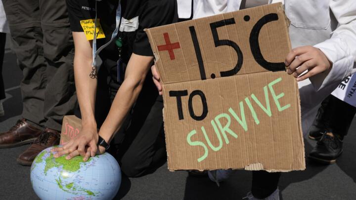Demonstrators pretend to resuscitate the Earth while advocating for the 1.5 degree warming goal to survive at the COP27 U.N. Climate Summit, Nov. 16, 2022, in Sharm el-Sheikh, Egypt.