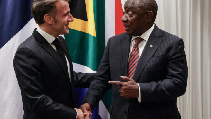 France's President Emmanuel Macron, left, shakes hands with South Africa's President Cyril Ramaphosa during their bilateral meeting at the Sandton Convention Centre in Sandton, South Africa.