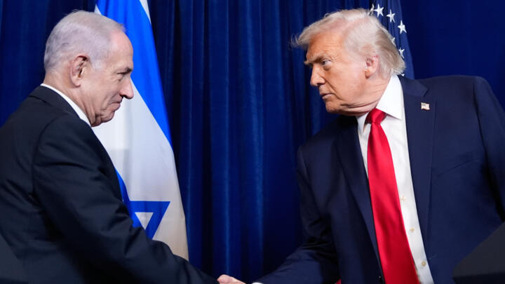 President Donald Trump shakes hands with Israel's Prime Minister Benjamin Netanyahu during a news conference at Mar-a-Lago, Dec. 29, 2025