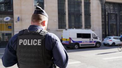Police stand outside the Bank of America building in Paris on March 28, 2026.