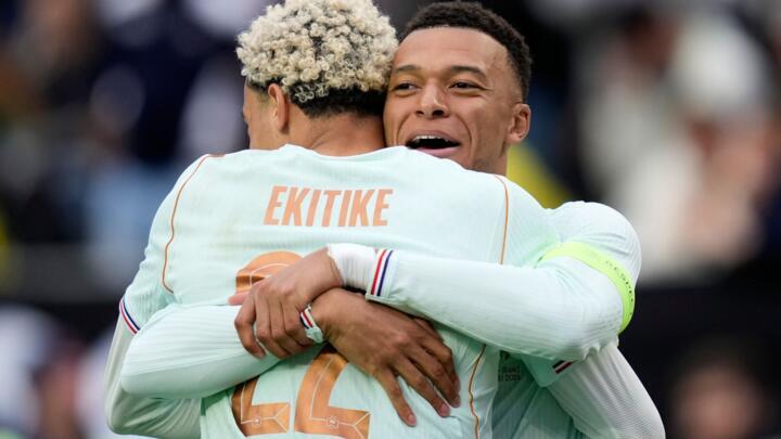 Hugo Ekitike of France embraces Kylian Mbappe after scoring his side's second goal past Brazilian goalkeeper Ederson during the international friendly match between Brazil and France.