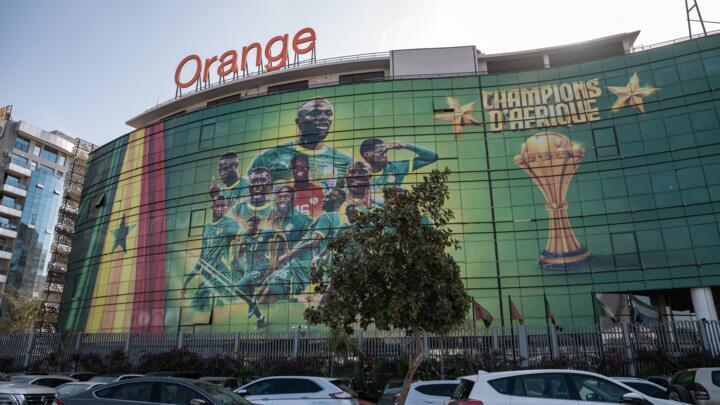 A large poster featuring the players of the Senegalese national football team bearing the words "Champions of Africa" displayed at the main Orange-Sonatel branch in the Keur Gorgui district of Dakar