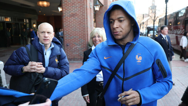 France's forward Kylian Mbappe signs autographs upon arriving at the hotel in Boston on March 24, 2026. 