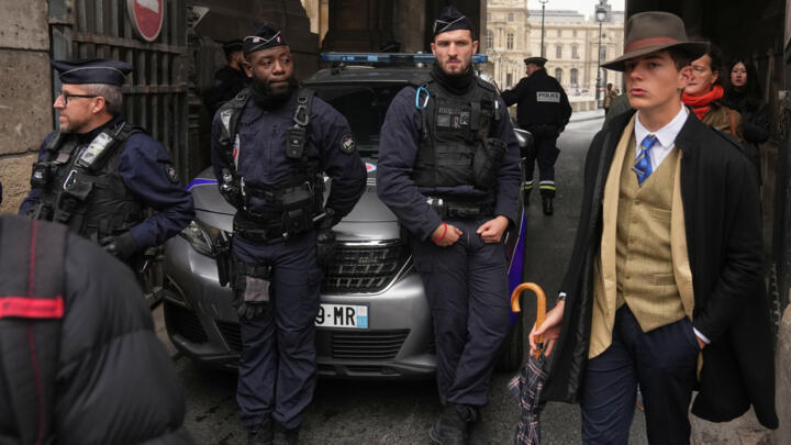 Police officers block an access to the Louvre museum after a robbery, October 19, 2025, in Paris.