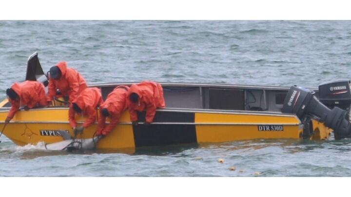 Members of the KwaZulu-Natal Sharks Board retrieve a dead Indian Ocean humpback dolphin